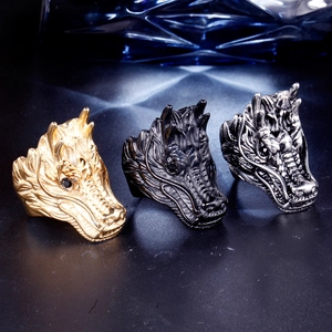 Detailed relief of dragon head rings in gold, matte black, and vintage silver finishes