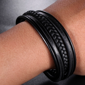 Close-up of multi-layer black braided leather bracelet with vintage punk style texture