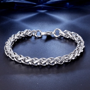 Polished silver Franco chain bracelet for men with secure lobster clasp on blue textured background