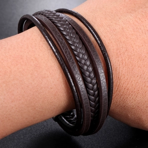 Detail of multi-layered brown braided leather bracelet with high-quality metal clasp