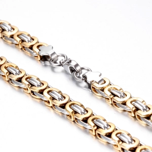 Macro shot of two-tone Byzantine chain with a silver and gold lobster clasp
