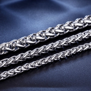 Men's stainless steel wheat link bracelets in three widths on dark textured background