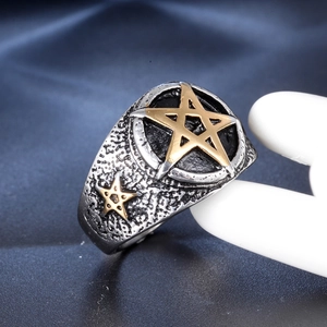 Vintage stainless steel ring for men featuring a gold star on a textured silver band
