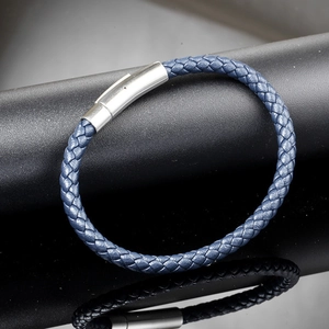 Close-up of deep blue braided leather bracelet with silver magnetic metal clasp