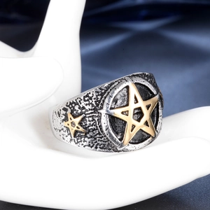 Vintage stainless steel ring with golden pentagram star on hammered rock texture