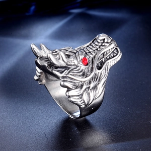 Close-up of vintage dragon ring in aged silver with a bright red rhinestone eye inlay