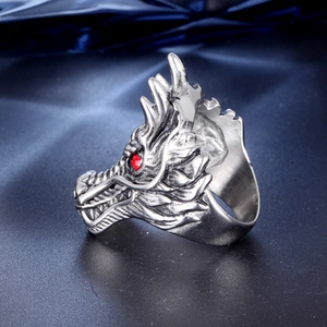 Detailed view of silver dragon head ring featuring a striking red zircon eye gemstone