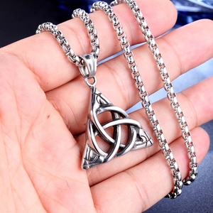 Retro stainless steel necklace with geometric triquetra knot pendant held in hand