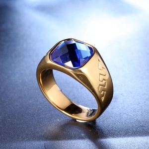 Golden stainless steel ring featuring a large square-cut blue agate and embossed wave patterns