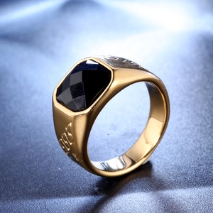 Detailed close-up of golden signet ring with black onyx stone and 2003 side engraving