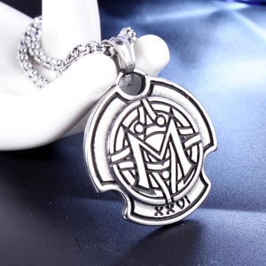 Detail of vintage stainless steel pendant necklace with M letter and XXVI engraving
