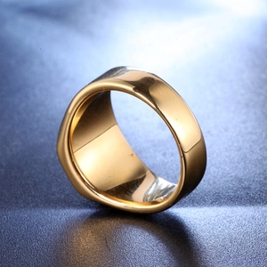 Macro shot of polished gold-finished stainless steel signet ring on a dark background