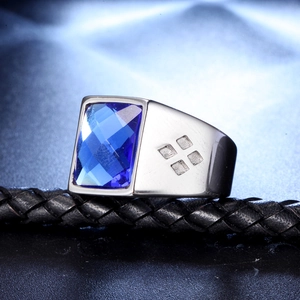 Macro detail of men's stainless steel ring with a large blue rectangular gemstone