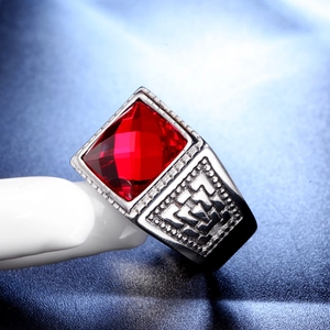 Macro side view of a men's vintage silver ring with a large square red gemstone