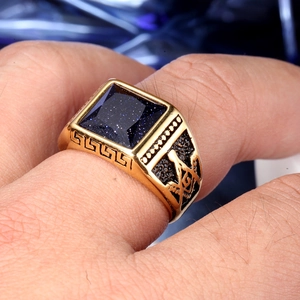Detailed close-up of gold-tone Masonic ring with square blue sandstone gemstone inlay