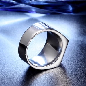 Close-up of a wide silver stainless steel ring with a minimalist polished finish