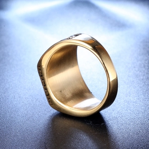Macro view of gold stainless steel ring featuring Greek Key patterns and polished finish