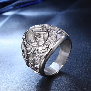 Macro detail of silver Masonic ring showing G symbol and Master engraving on steel band