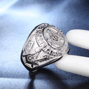 Macro view of Masonic G symbol and relief carvings on vintage stainless steel ring