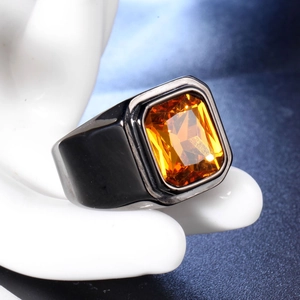 Vue macro d'une large bague noire pour hommes avec une grande pierre orange rectangulaire
