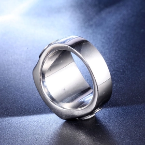 Detailed close-up of a wide polished silver titanium steel ring with a smooth mirror finish