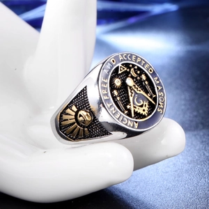 Macro view of Masonic skull ring with compass logo and gold accents on black enamel