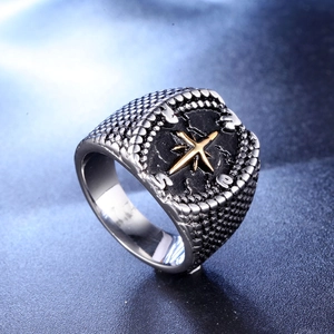 Vintage stainless steel men's ring featuring a gold compass star and engraved details