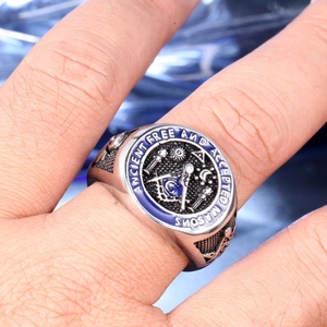 Macro detail of men's Masonic skull ring with blue enamel and engraved ancient masons text