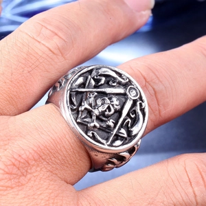 Macro detail of gothic skull and masonic compass emblem on vintage steel ring