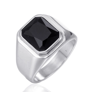Macro shot of silver titanium steel signet ring featuring a large faceted black gemstone