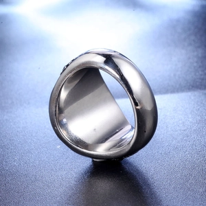 Detailed close-up of retro silver stainless steel ring with black engraved textures