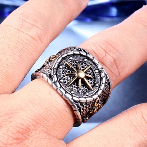 Detailed view of vintage steel anchor ring with gold compass relief on the band