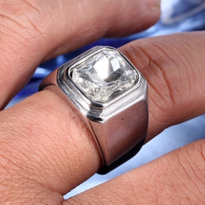 Close-up of polished stainless steel men's ring with a large square-cut clear stone