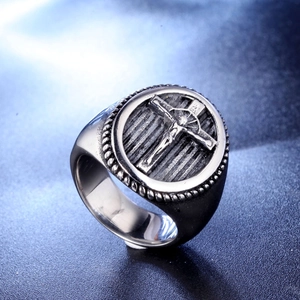 Macro shot of vintage titanium steel ring featuring an ornate Jesus crucifix carving