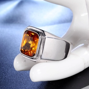 Detailed shot of a silver titanium steel men's signet ring with a rectangular orange gemstone