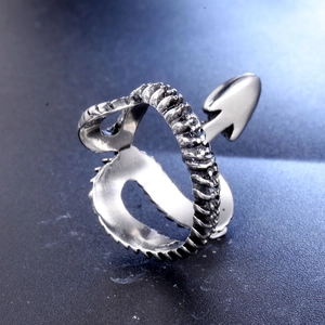 Macro shot of silver titanium steel ring with spine texture and arrowhead details