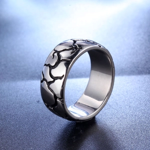 Vintage style wide silver titanium steel ring with unique cracked texture on dark surface