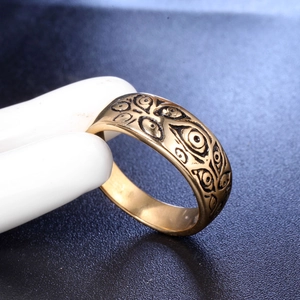 Macro view of gold vintage titanium steel ring with engraved evil eye patterns