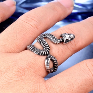 Detailed close-up of a vintage silver gothic snake bone ring worn on a finger