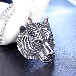 Macro shot of detailed retro tiger head pendant with punk style on beaded metal chain
