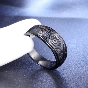 Detailed macro view of gothic punk black eyeball relief pattern on titanium steel ring