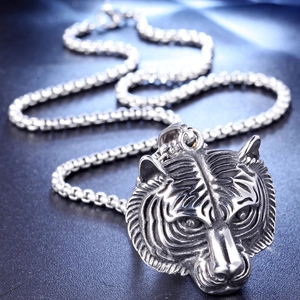 Macro shot of silver tiger head pendant with bold square pearl chain in punk style