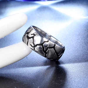 Vintage style wide stainless steel ring with black crackle patterns on silver surface