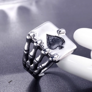 Gothic titanium steel ring featuring a skull hand holding an ace of spades card