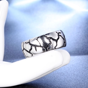 Detailed view of men's stainless steel ring with vintage black crackle texture finish