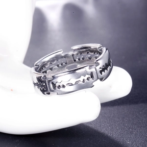 Punk style silver stainless steel razor blade ring on a white hand display model