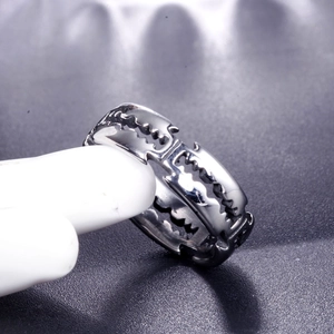Industrial style stainless steel ring with jagged cutout design on a display model