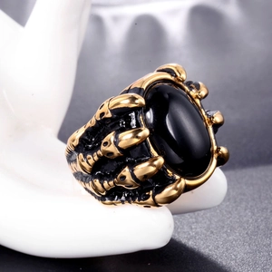 Gothic punk men's ring with black oval gemstone held by vintage golden dragon claws