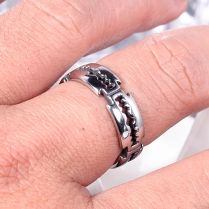Close-up of a silver stainless steel ring with unique jagged sawtooth edge punk design