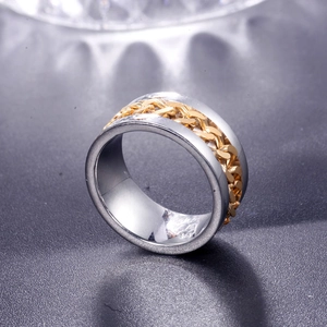 Macro shot of bicolor titanium steel ring with golden cuban link chain inlay detail
